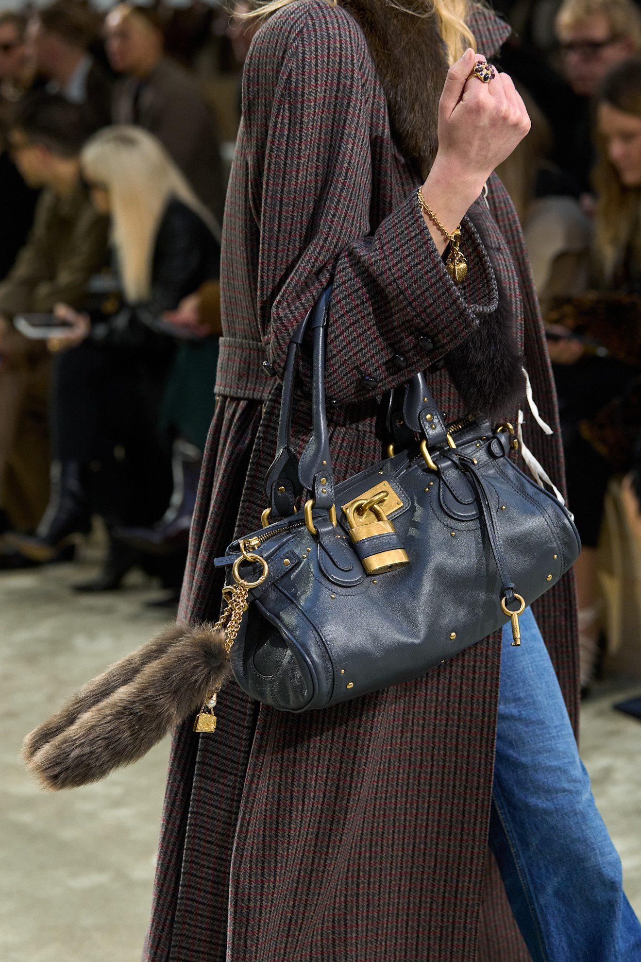a model on Chloe&#039;s Fall 2025 runway carrying a blue Paddington bag.