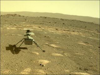A photograph taken by the Perseverance rover of the Ingenuity helicopter on the surface of Mars in April 2021, just after the rover deployed the chopper.
