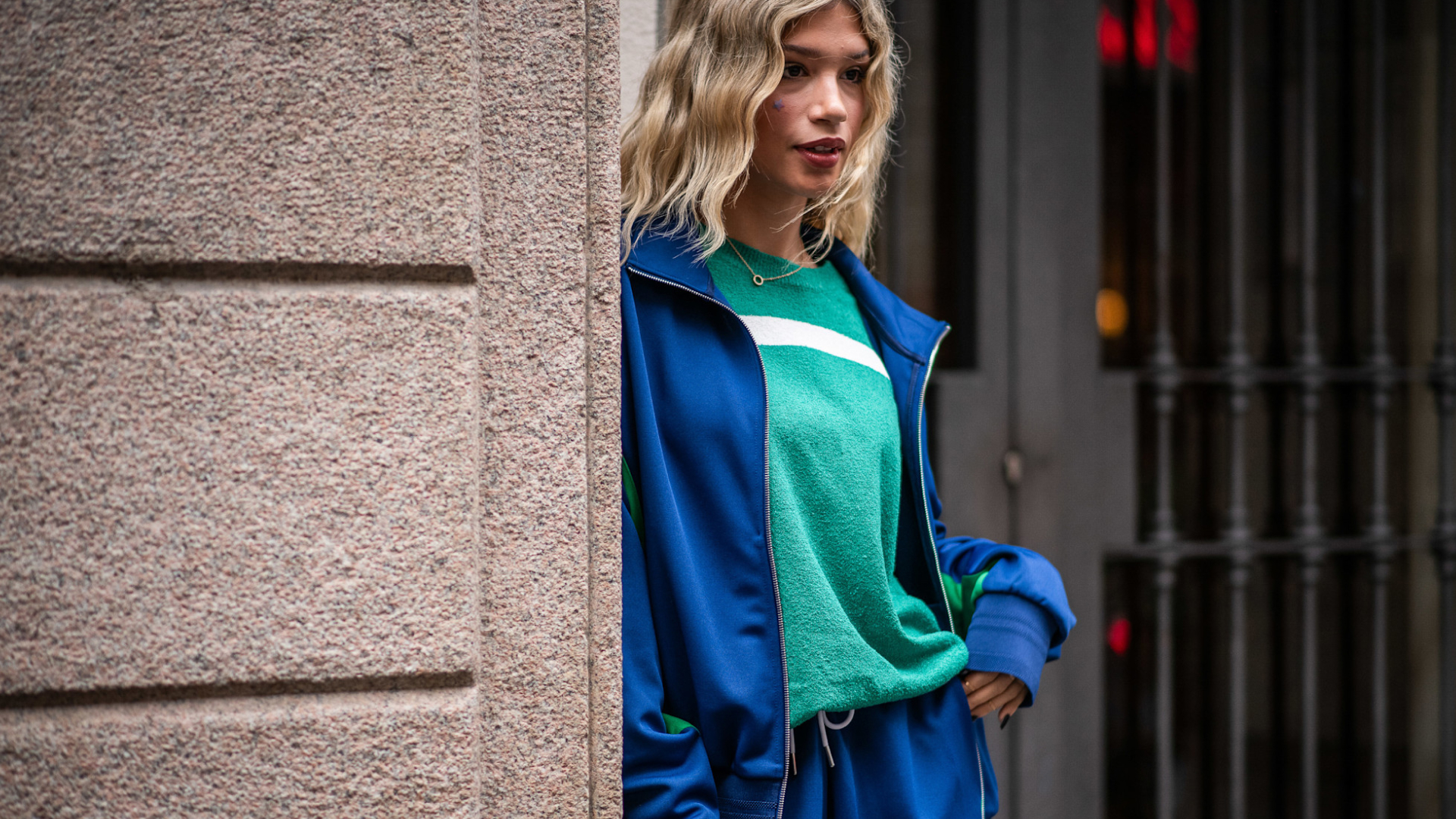 woman wearing athleisure: blue sweats and a hoodie