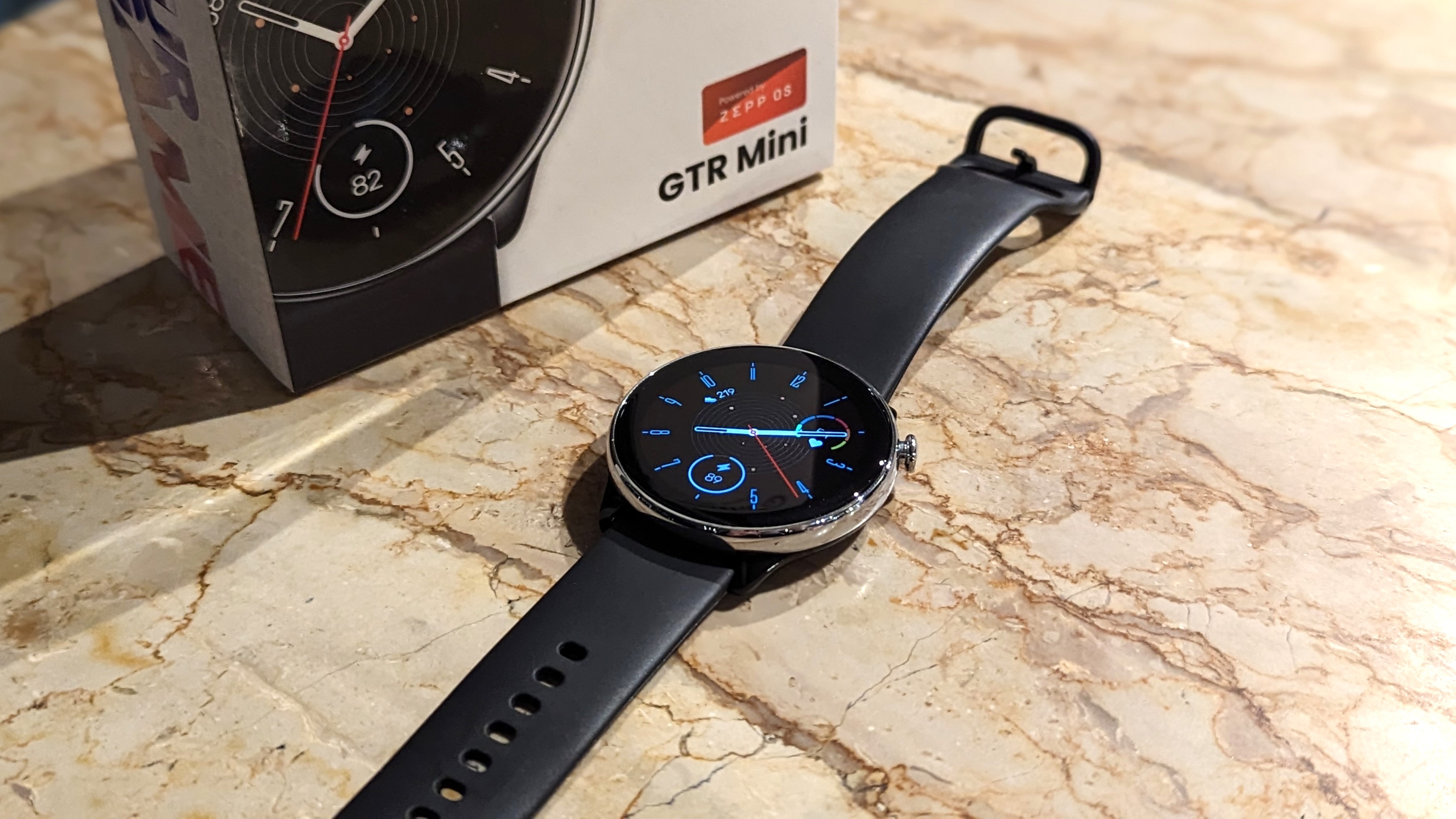 Amazfit GTR Mini smartwatch kept on a marble table.