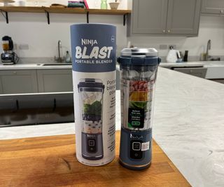 Unboxing the Ninja Blast - the Ninja Blast out of its cardboard packaging. You can see the sticker telling you to charge it for 2 hours and the guide to the right order to add your ingredients.