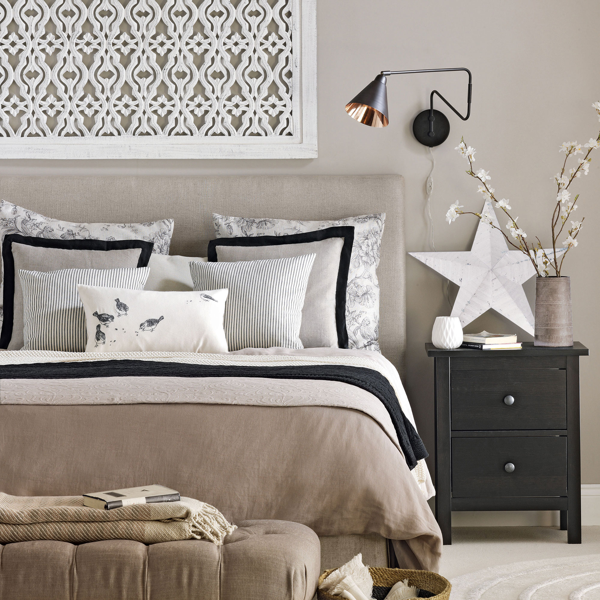 Neutral bedroom with white decorative panel above headboard