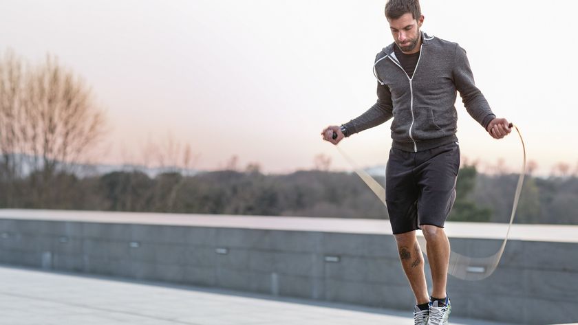 Man jumping rope next to the river