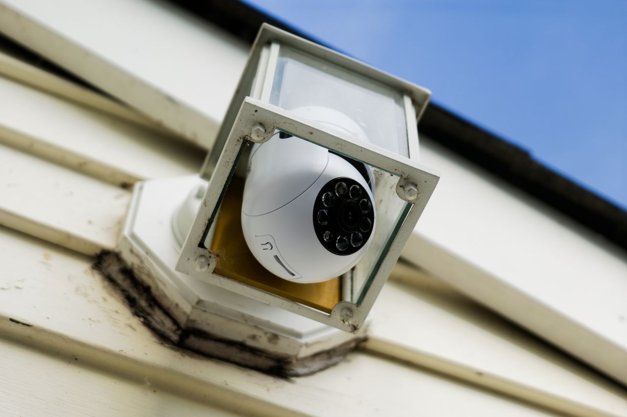 Symynelec security camera light bulb installed outdoors inside of light fixture.