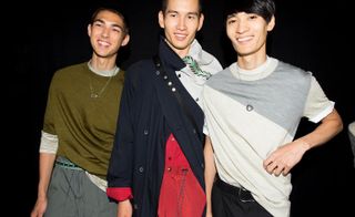 three male models at a fashion week wearing casual clothing