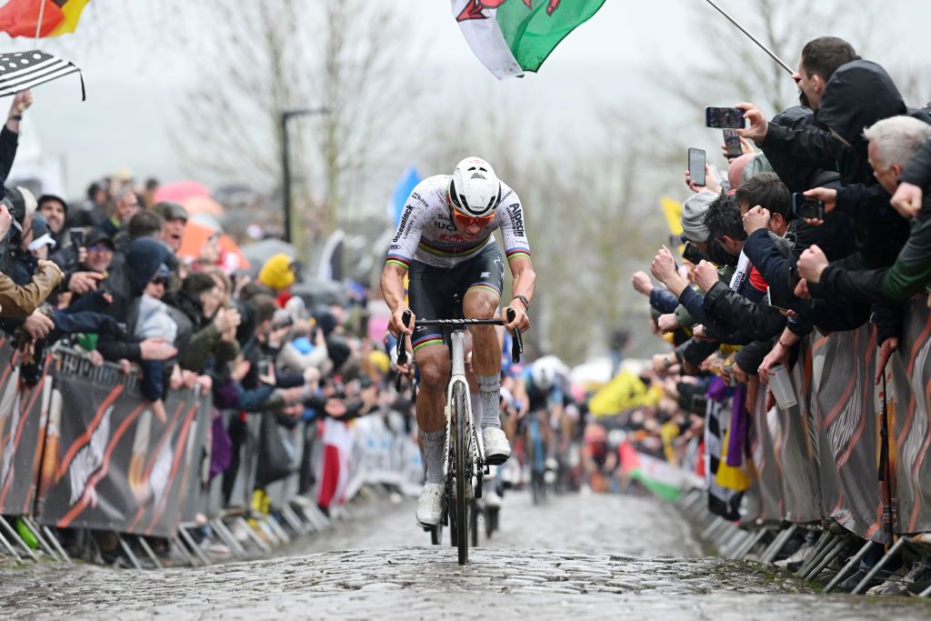 OUDENAARDE BELGIUM MARCH 31 Mathieu van der Poel of The Netherlands and Team Alpecin Deceuninck attacks passing through a cobblestones sector while fans cheer during the 108th Ronde van Vlaanderen Tour des Flandres 2024 Mens Elite a 2708km one day race from Antwerpen to Oudenaarde UCIWT on March 31 2024 in Oudenaarde Belgium Photo by Dario BelingheriGetty Images