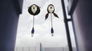 Two girls hanging by giant face balloons