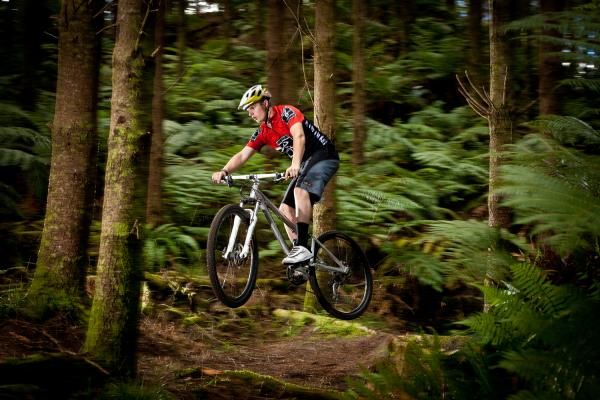 Blazing through lush forest singletrack on Old Chevy trail in Rotorua
