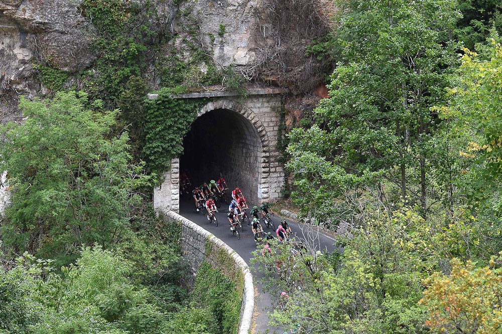 The peloton emerges from a tunnel during stage 14.