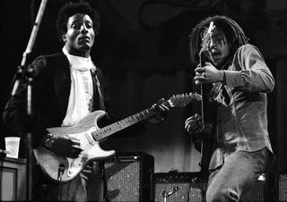 Al Anderson and Bob Marley of The Wailers perform on stage at the Odeon, Birmingham, United Kingdom, 18 July 1975.