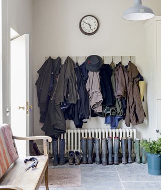 utility room with variety of clothes and shoes