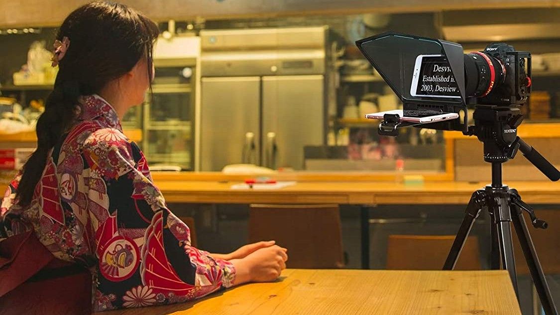 Woman looking into camera connected to Desview Teleprompter, one of the best teleprompters