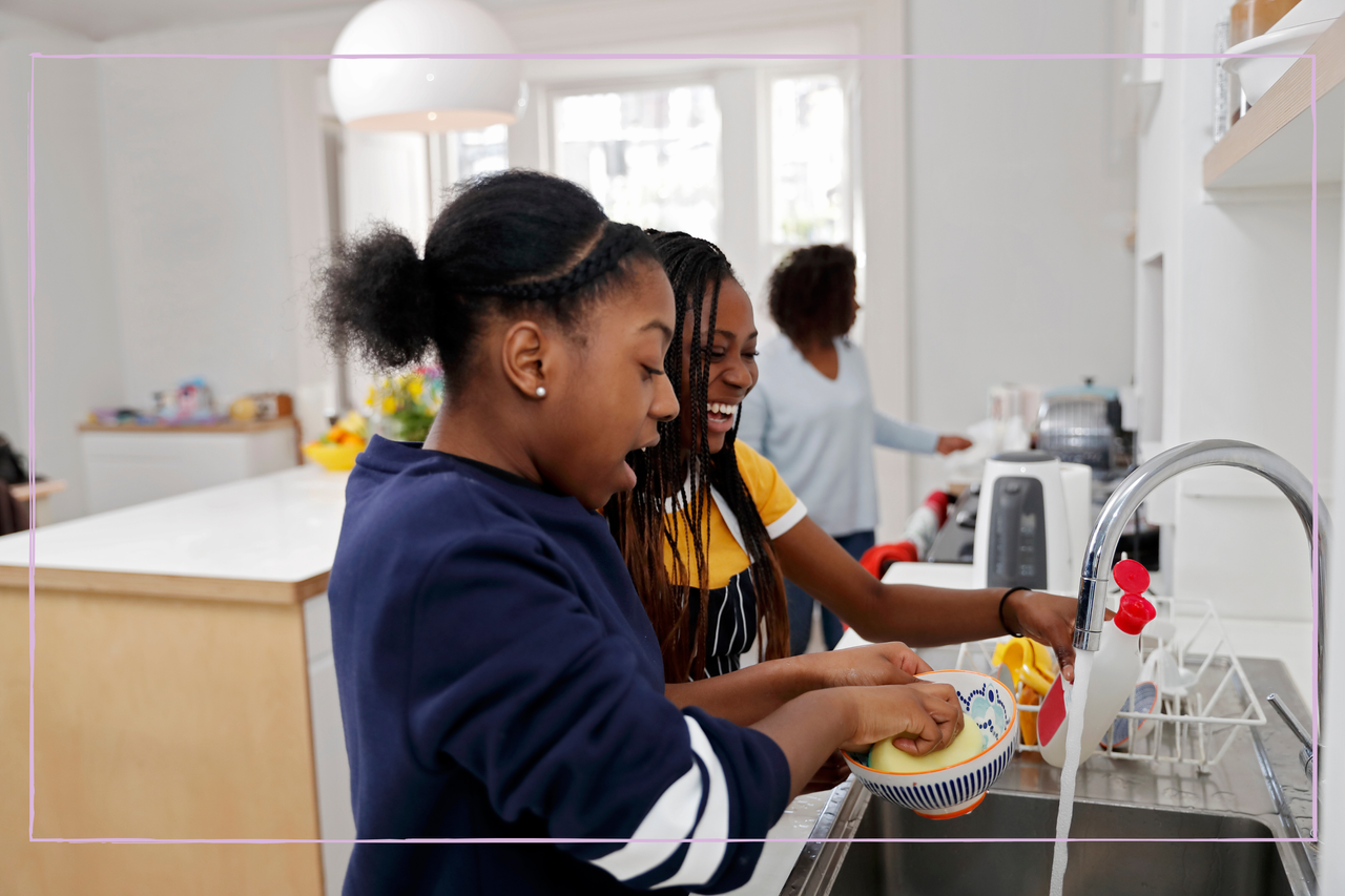 Teenage girls doing the washing up