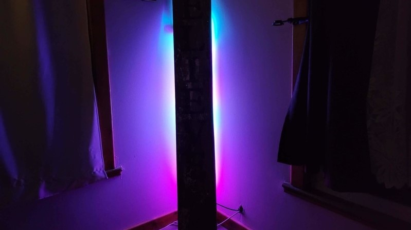 Govee Lyra smart floor lamp on a wooden floor in a dark room