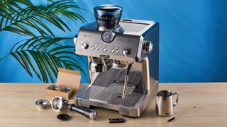 De'Longhi La Specialista Opera is a stainless steel manual espresso machine with smart tamping, a group handle, steam wand, and grinder