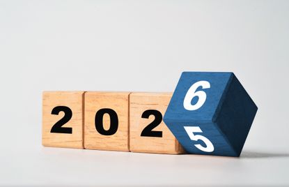Flipping of 2025 to 2026 on a wooden block cube for new year change
