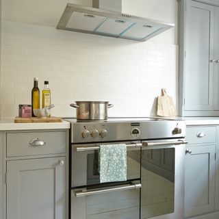 Grey kitchen with silver oven and extractor fan