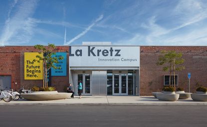 Exterior of the La Kretz Innovation Campus building with brick walls and silver metal entranceway