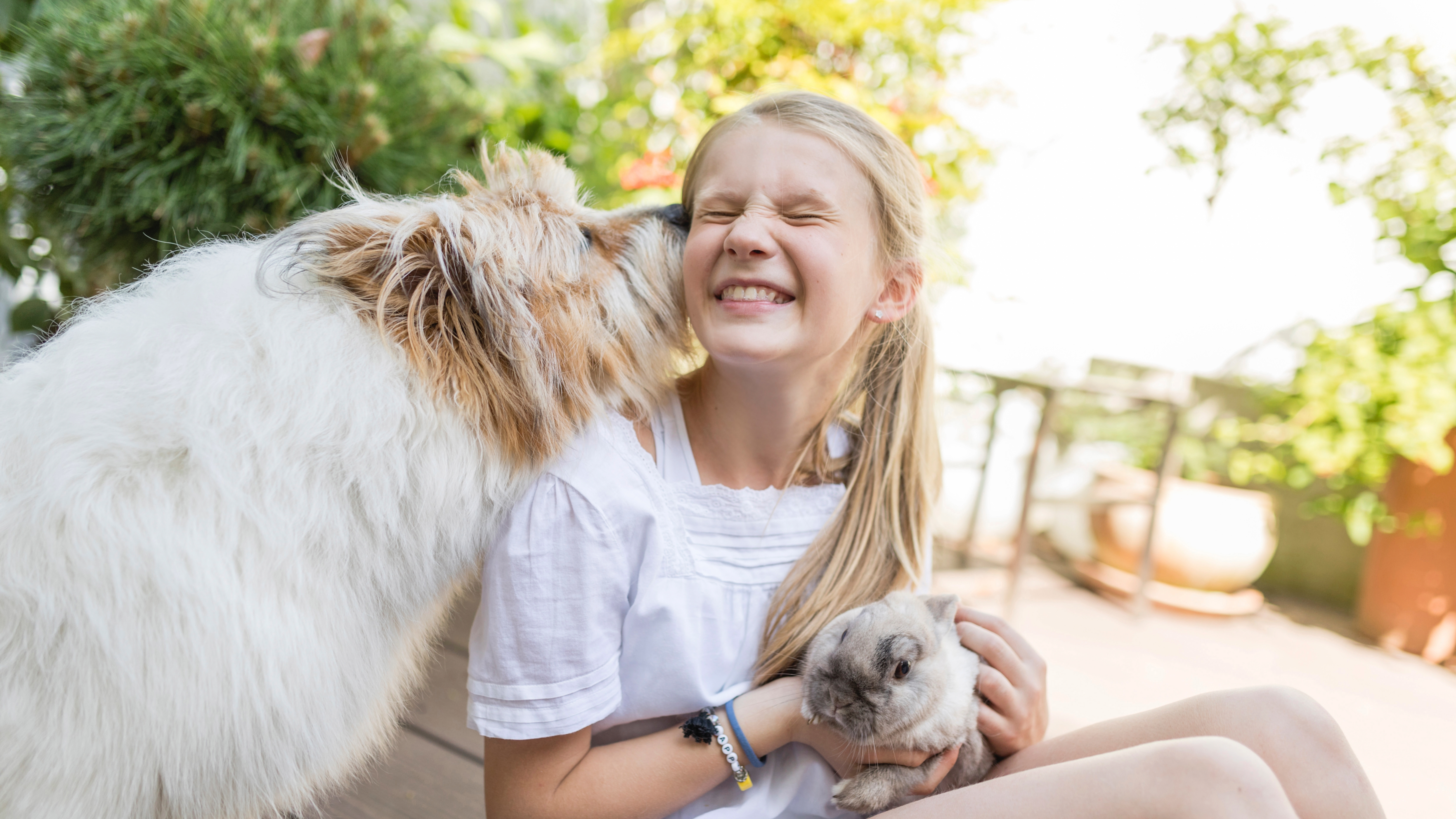 Young girl with dog and rabbit