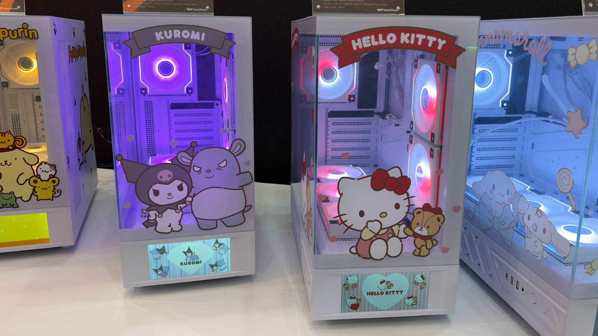 Four of darkFlash's latest co-branded Sanrio PC case collaboration. From left to right, the PC case designs feature PomPomPurin, Kuromi, Hello Kitty, and Cinnamoroll.