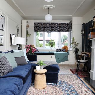 grey living room with blue velvet sofa