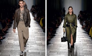 Side by side photos of male and female models walking along the catwalk. The male is wearing a brown leather jacket, camo. top and brown trousers. The female is wearing a dark grey trench coat with black ankle boots and a black handbag.