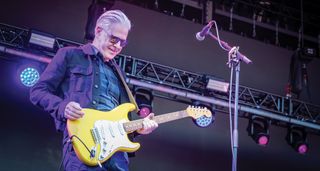 Gregory Philps of Deacon Blue plays his yellow Stratocaster onstage