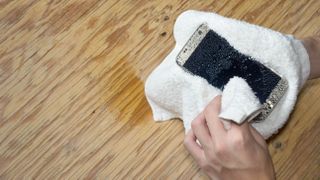 A phone being dried by a cloth