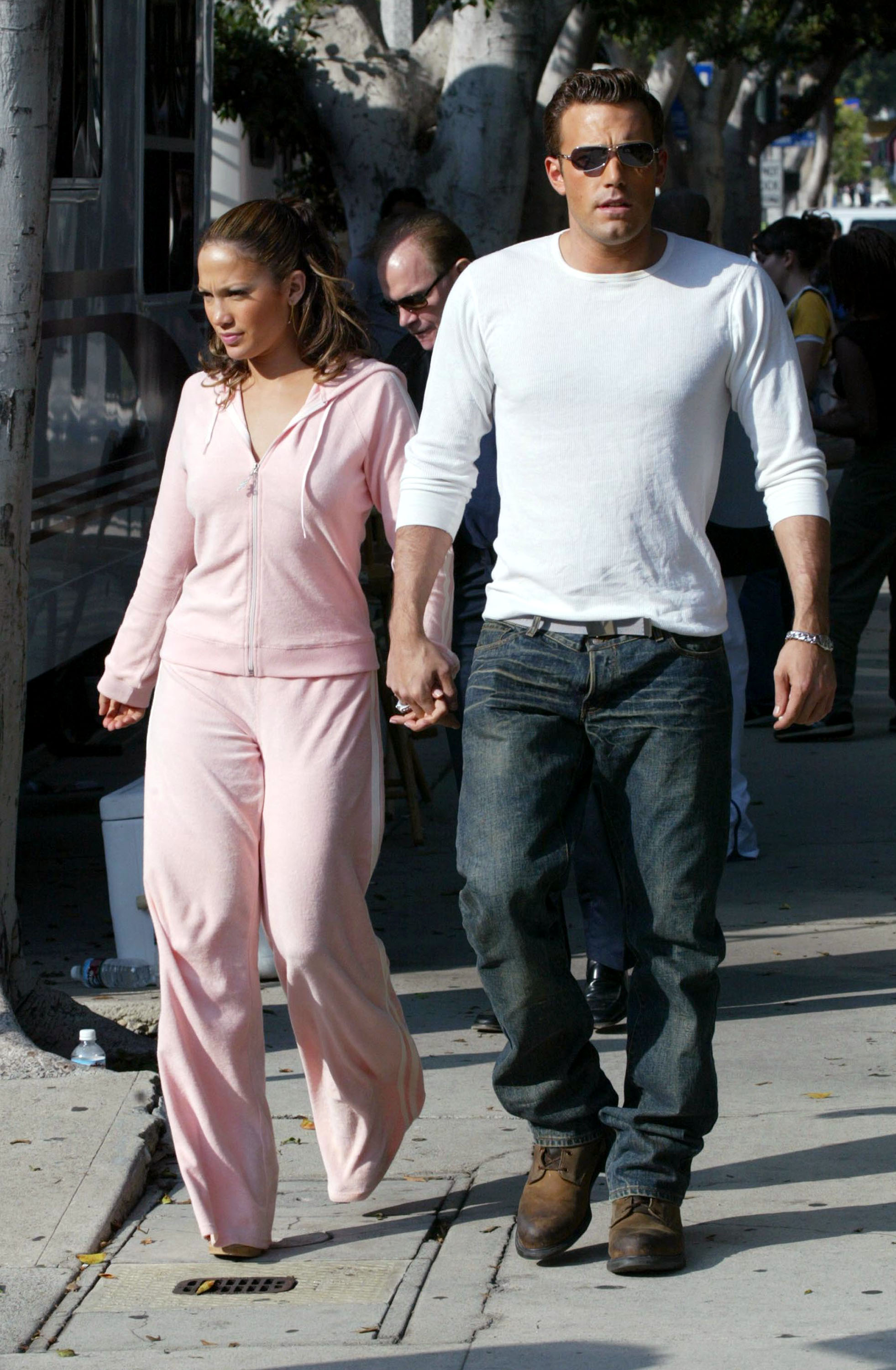 Jennifer Lopez and actor Ben Affleck hold hands while filming her new music video at Barefoot restaurant on October 20, 2002 in Beverly Hills, California. (Photo by Mel Bouzad/Getty Images)
