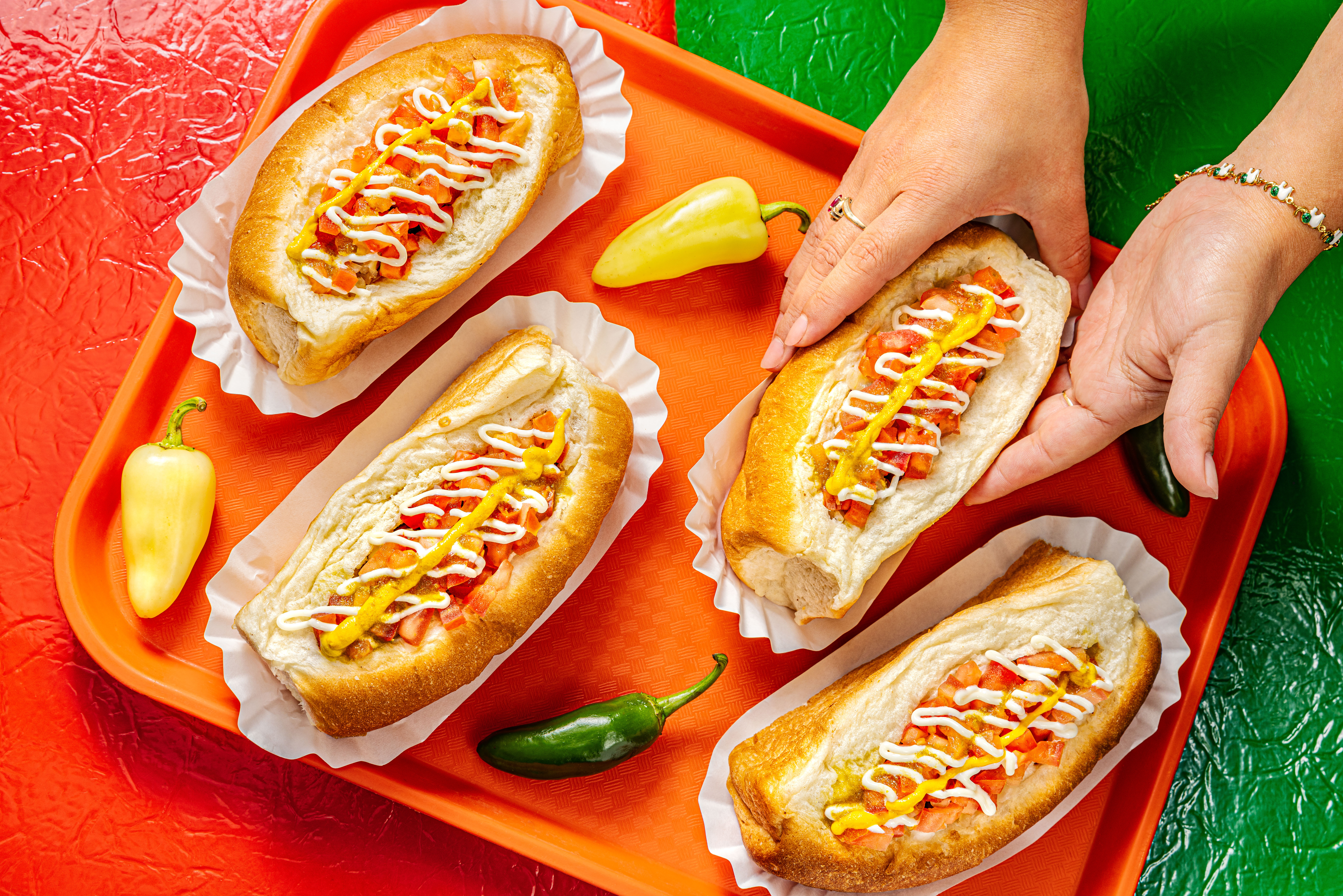 Four Sonoran Dogs on an orange tray