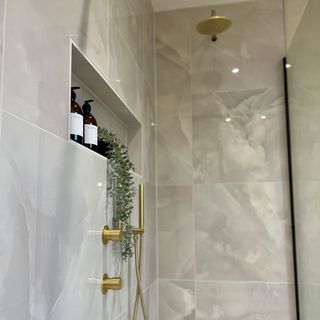 shower with glass door, gold hardware and glass door