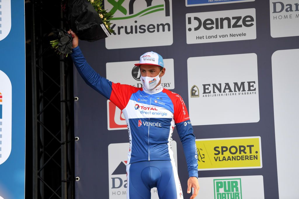 NOKERE BELGIUM MARCH 17 Podium Damien Gaudin of France and Team Total Direct Energie Celebration during the 75th Nokere Koerse Danilith Classic 2021 Mens Elite a 1955km race from Deinze to Nokere Mask Covid safety measures Flowers NokereKoerse on March 17 2021 in Nokere Belgium Photo by Luc ClaessenGetty Images