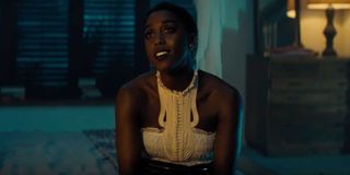 No Time To Die Lashana Lynch sitting on the side of a bed, talking