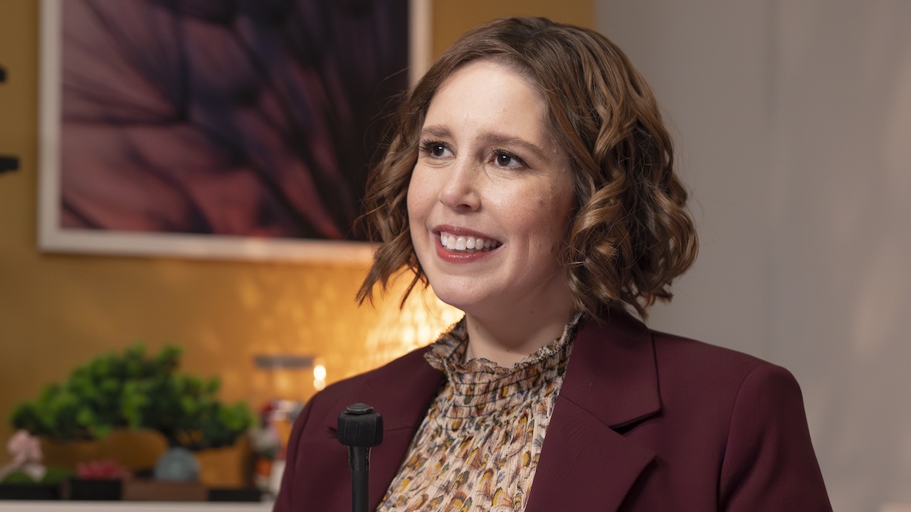 Sibby Wilson holding microphone in her office in Scrubs Season 10