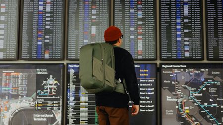 The Peak Design Travel 2-in-1 Backpack worn by a traveler