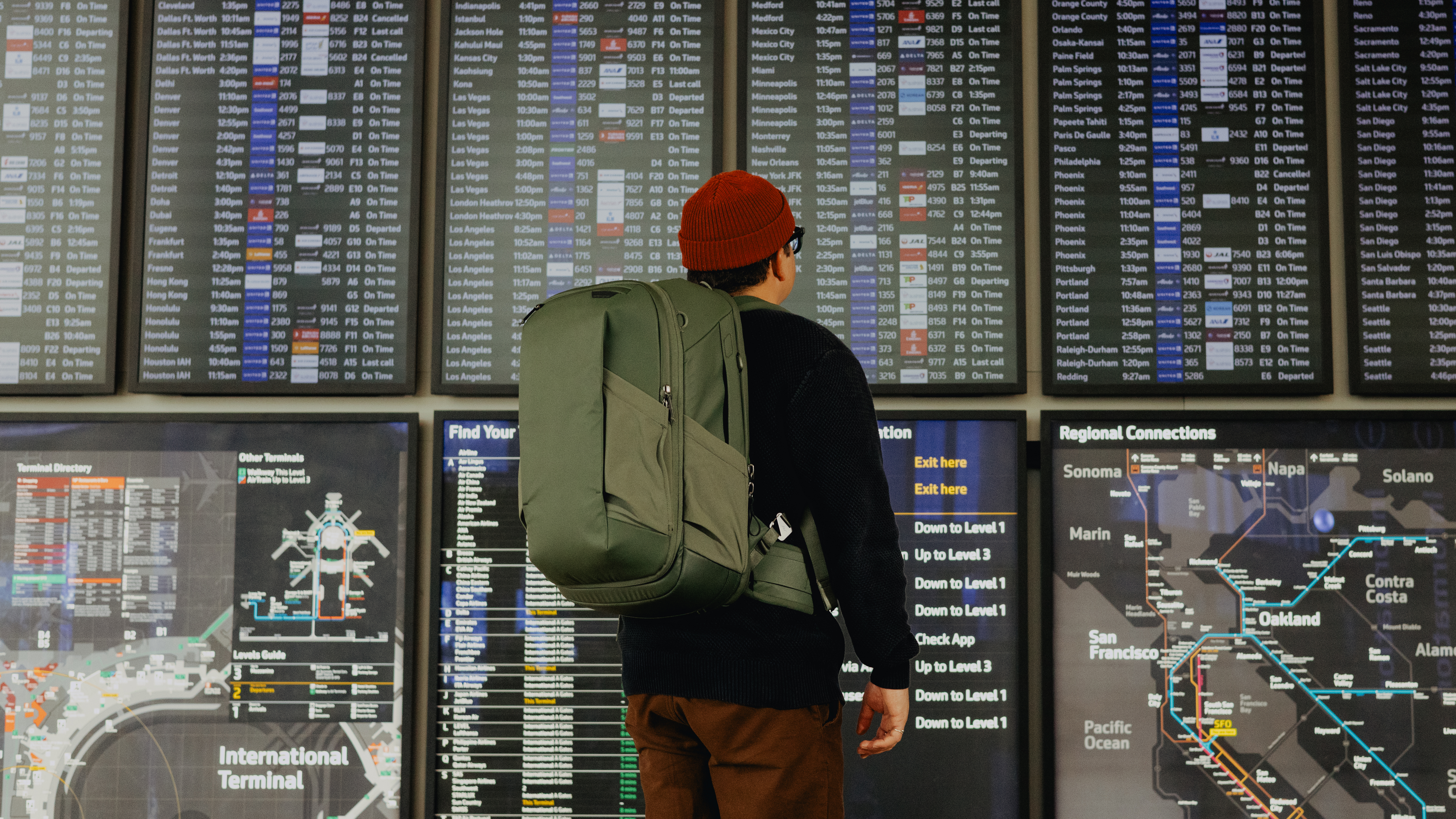 The Peak Design Travel 2-in-1 Backpack worn by a traveler