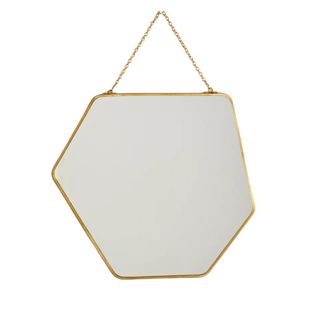An abstract shaped mirror with a gold frame and hanger