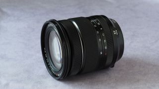 Fujinon XF 16-80mm f/4 R OIS WR camera lens on a marbled surface