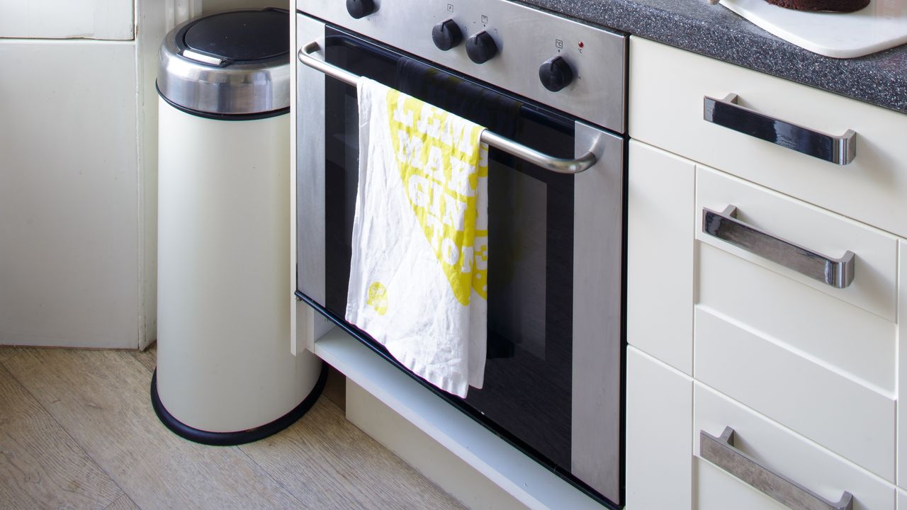 Close-up of a kitchen with an oven and a bin