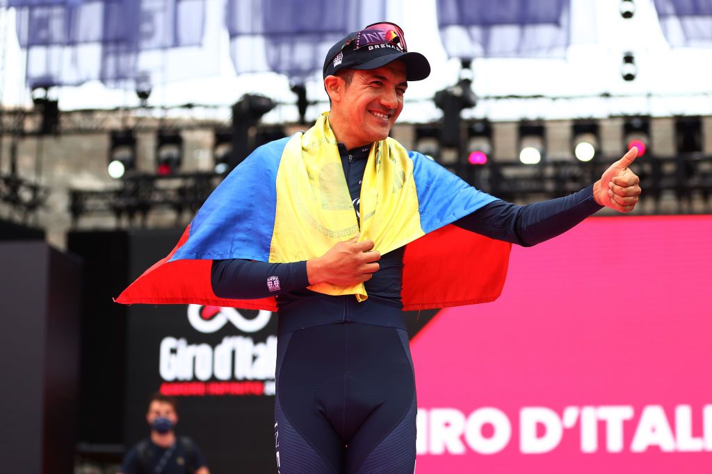 VERONA ITALY MAY 29 Richard Carapaz of Ecuador and Team INEOS Grenadiers celebrates at podium with the Ecuador flag as second overall place during the 105th Giro dItalia 2022 Stage 21 a 174km individual time trial stage from Verona to Verona ITT Giro WorldTour on May 29 2022 in Verona Italy Photo by Michael SteeleGetty Images