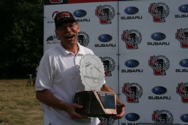 WORS Series Director Don Edberg accepts the Border Battle Trophy on behalf of racers in the Wisconsin Off Road Series, who defeated the Minnesota State Championship Series riders for the second year running.