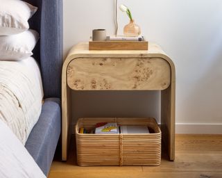 Rounded bedside table with storage basket underneath