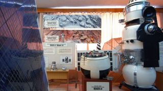 The descent vehicle of the Venera 8 spacecraft (left) and its parent spacecraft are seen in a Russian museum.
