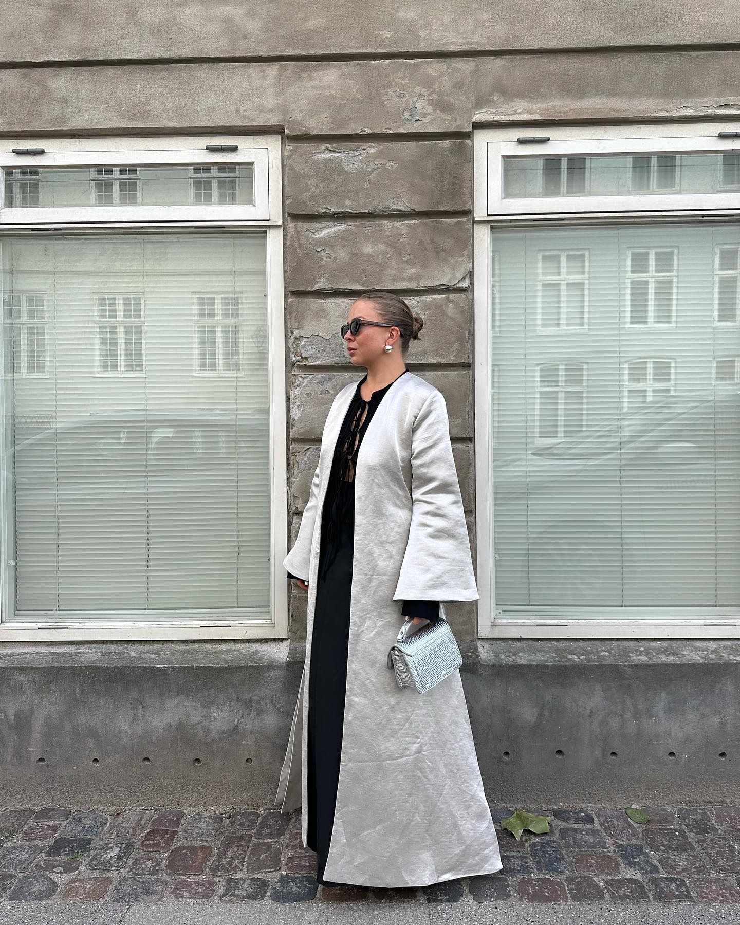 Dina Hansen wearing a satin evening coat