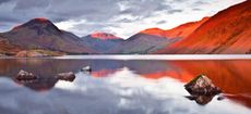 The Scafell range across the reflective waters of Wast Water in the Lake District National Park, Cumbria, England, UK