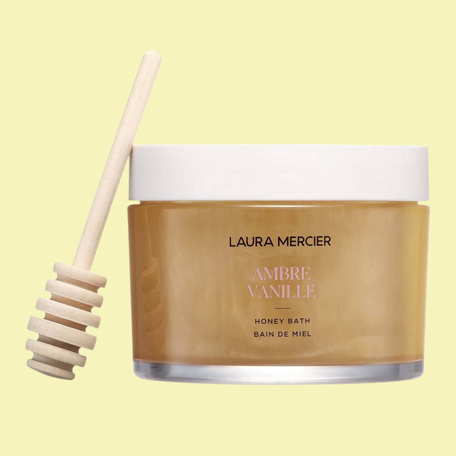 A tub of bath lotion with a honey dipper