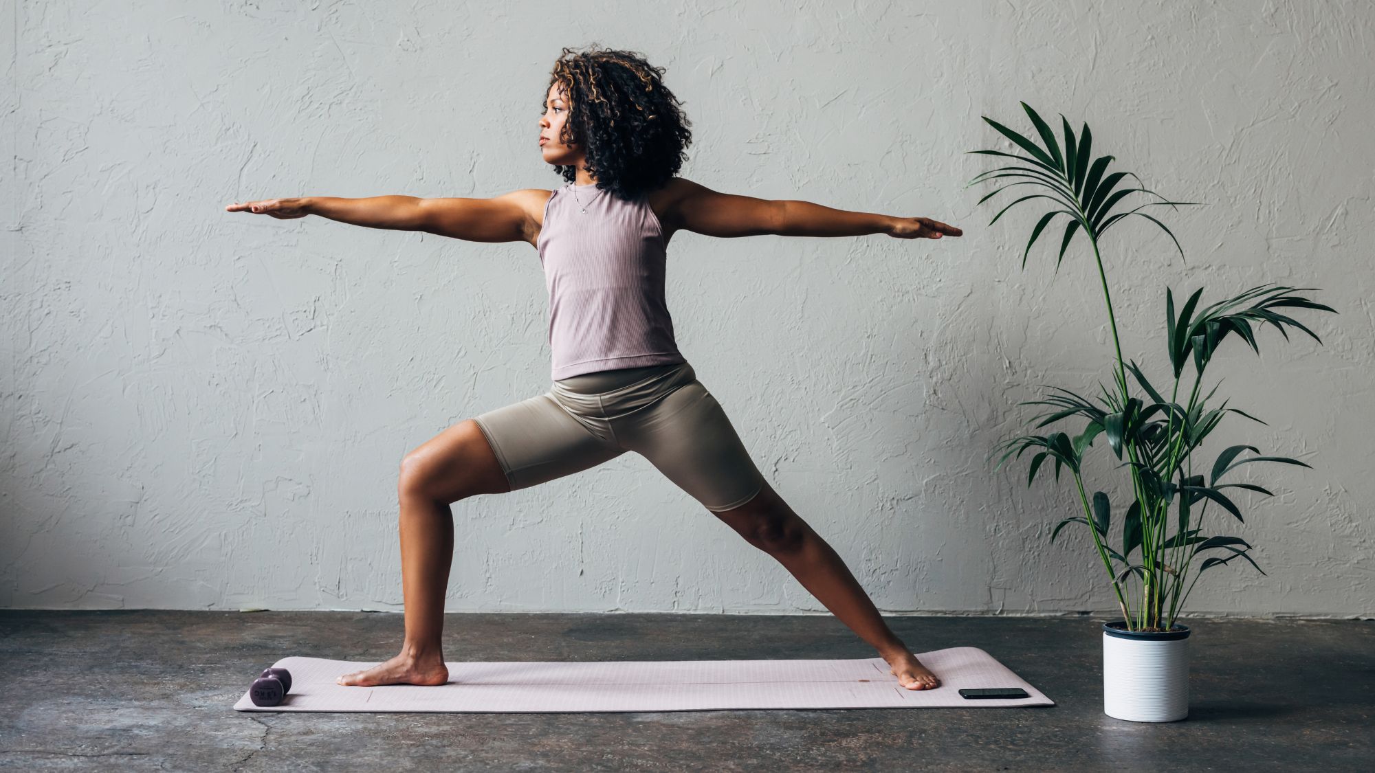 A woman doing one of the best yoga flows for core strength: at home, on her yoga mat