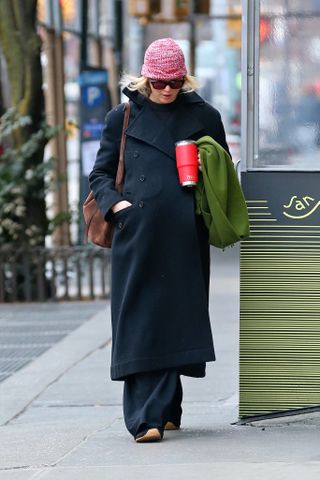 Jennifer Lawrence walks in Manhattan wearing a Dior coat with La Ligne pants Loewe sneakers and her Liffner bag