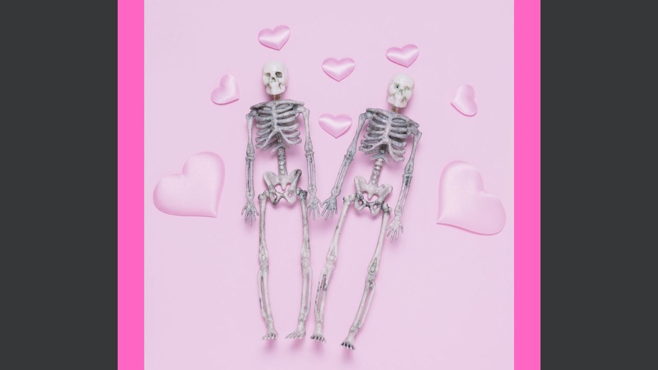 halloween sex positions feature image: two skeletons holding hands on pink background with hearts