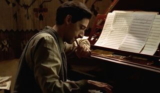 Adrien Brody composes a song at his piano in The Pianist.